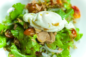 Thai tuna salad with egg, spicy Tuna Salad onion and tomatoes in plate.