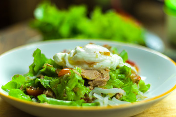 Thai tuna salad with egg, spicy Tuna Salad onion and tomatoes in plate.