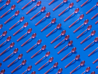Pink spoons pattern on blue background