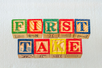 The term first take visually displayed using colorful wooden blocks on a clear background image...