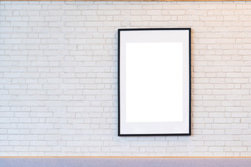 Beautiful black wooden picture frame on white brick wall with space for text and advertising