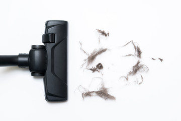 Dark head of a modern vacuum cleaner being used while vacuuming