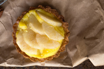  Pear tart with  pecan nuts  and custard cream, top view, flat lay , vertical composition