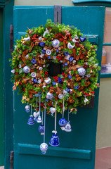 Christmas door wreath decorated with ceramic details made by Czech masters in Old Prague.