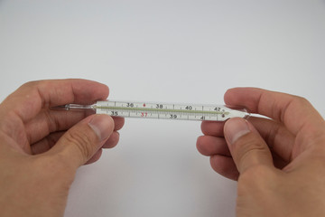 Medical thermometer in the hands on a white background