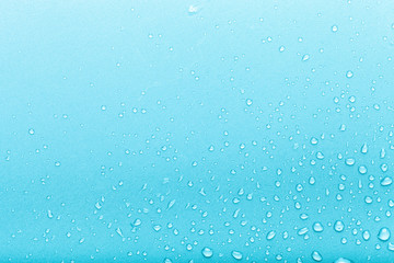 Drops of water on a color background. Blue. Toned