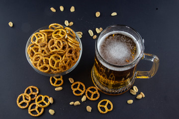 Bright, cold beer in a glass beaker with crackers