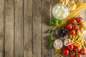 Table with ingredients to prepare italian pasta