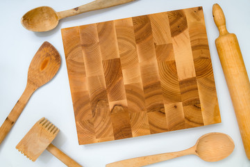 Handmade wooden board and kitchen tools on white background: woo