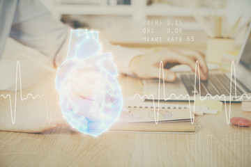 Heart drawing with man working on computer on background. Medical concept. Double exposure.