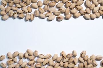 Pistachios nuts on white background with space for type. Food mi