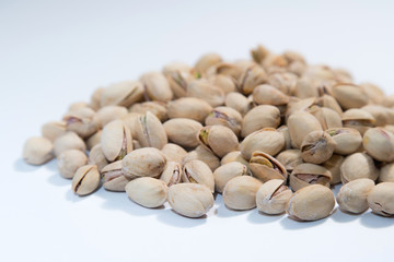 Pistachios nuts on white background with space for type. Food mi