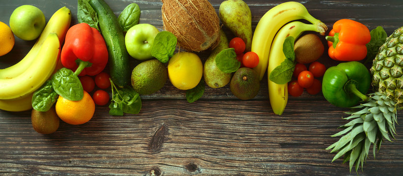 Fruti and vegetables background. Different fruits and vegetables over wooden background. Banner. Copy space.