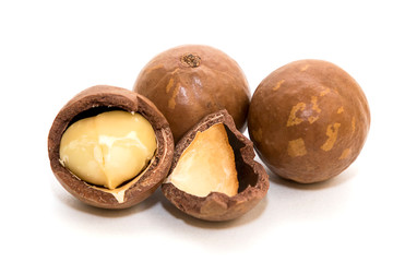 Macadamia oil and nuts on white background