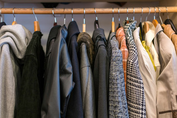 Wardrobe full of different color, material and texture clothes,