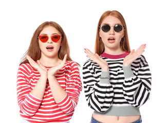 Portrait of shocked young women on white background