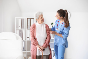 Medical worker with senior woman in nursing home