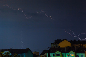 a flash of lightning in the night sky over the city