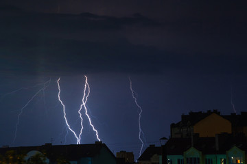 bright flashes of lightning in the night sky over the city