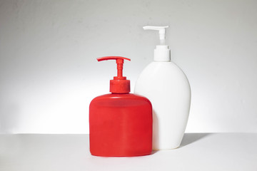 Red and white plastic bottles. Bottles with dispenser. On a white background.