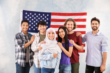 Group of students near wall with USA flag