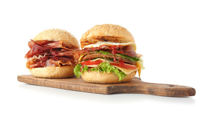 Tasty burgers with bacon on white background