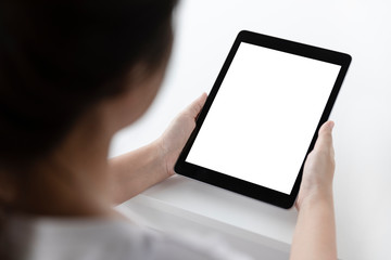 Woman hands using tablet and blank white screen on table with clipping path.