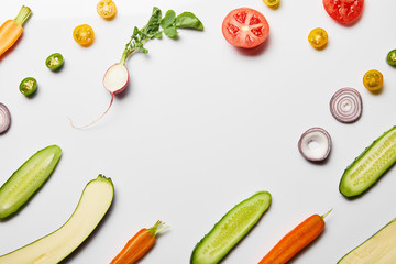 top view of fresh sliced vegetables on white background with copy space