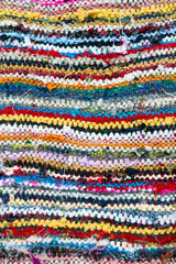 Colorful textile abstract background in a full frame close-up of imperfect woven layers