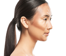 Asian woman with contouring makeup on white background