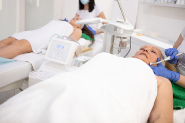 Together in cosmetic spa salon, mam and daughter