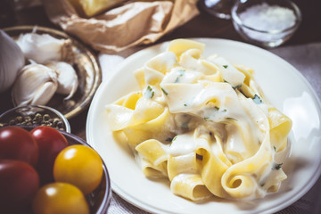 Traditional Italian Alfredo Pasta Plate with Creamy Cheese and Basil Sauce