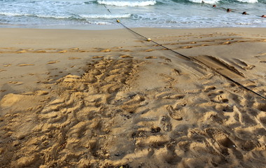 footprints in the sand on the shores of the Mediterranean in the north of the state of Israel