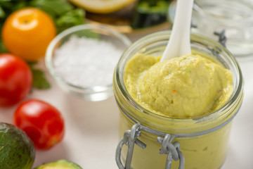 Vegan Raw and Healthy Fresh Food Concept. Organic Green Avocado Spread Guacamole in Jar.