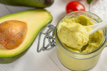 Vegan Raw and Healthy Fresh Food Concept. Organic Green Avocado Spread Guacamole in Jar.