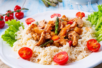 Turkey fricassee on rice with asparagus and paprika