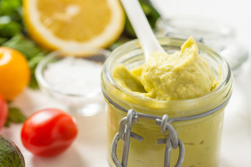 Vegan Raw and Healthy Fresh Food Concept. Organic Green Avocado Spread Guacamole in Jar.