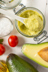 Vegan Raw and Healthy Fresh Food Concept. Organic Green Avocado Spread Guacamole in Jar.