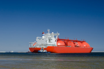 GAS TANKER  - The big ship maneuvers in the mooring port at the wharf