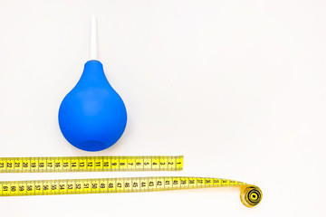 yellow tailor measure to determine waist with enema, isolation