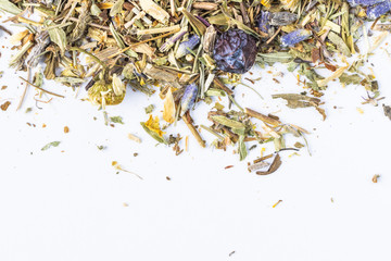 Herbal tea scattered on a white background. Thyme herbs, lavender, chamomile, juniper, St. John's wort. Top view, macro, flat lay, minimalism. Useful vitamin herbal collection.  Copy space.