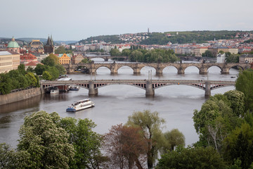 Fototapeta premium Bridges of Prague over Vltava River at dusk. Scenic view from Letna Hill in Prague, Czech Republic