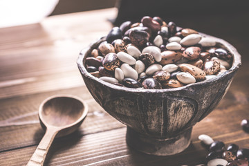 Colorful Beans and Wooden Spoon on Rustic Dark Background