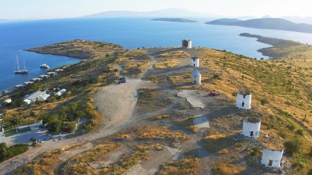 Aerial survay over windmills in Bodrum, Turkey. Spectacular landscape at sunset. Welcome to Turkey concept 4k