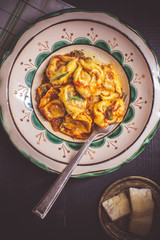 Tortellini with Tomato Sauce, Mozzarella Cheese and Basil on Rustic Plate