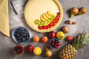 Fruit Tart Pie Preparation with Fresh Dough and Colorful Fruits Ready to Bake