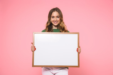 Smiling blonde woman holding blank board and looking at camera