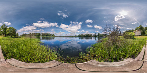 full seamless spherical hdri panorama 360 degrees  angle view on wooden pier of huge lake or river...