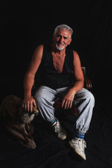 portrait of white bearded hipster man sitting in a photo studio