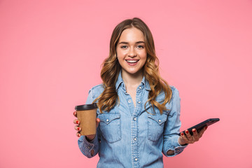 Smiling woman wearing in denim shirt holding cup of coffee